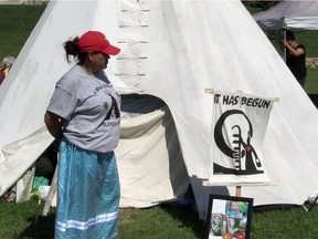Darla Fourstar, who was in the foster care system as a child, stands by the teepee at the Healing Camp for Justice in Saskatoon's Victoria Park in support of her friend Chris Martell. STARPHOENiX PHOTO