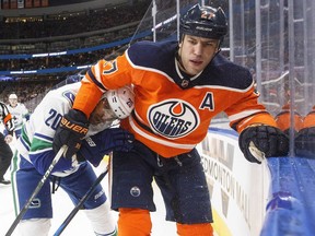 Vancouver Canucks Brandon Sutter (20) is grabbed by Edmonton Oilers' Milan Lucic (27) during second period NHL action in Edmonton, Alta., on Saturday January 20, 2018.