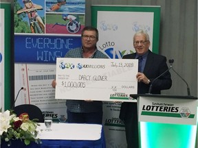 Darcy Glover, left, of Dalmeny receives a cheque for a little more than $1 million from Jerry Shoemaker, Vice President, Saskatchewan Lotteries, on Thursday, July 26, 2018 at the Sask. Lotteries office in Saskatoon. Glover purchased the winning Lotto Max ticket  on July 13 at the Dalmeny Gas Bar & Liquor Store on Highway 305 South. Jeff Losie/Saskatoon StarPhoenix
