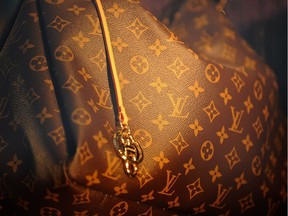 A Louis Vuitton Monogram bag sits on display in a store window in Paris, France, on Thursday, March 31, 2011. LVMH Moet Hennessy Louis Vuitton SA Chief Executive Officer Bernard Arnault repeated he doesn't plan on taking control of Hermes International SCA, in which his company has built up a 20.2 percent stake. Photographer: Antoine Antoniol/Bloomberg