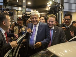 Mexico's President-elect Andres Manuel Lopez Obrador is surrounded by the press as he leaves a hotel where he gave a press conference in Mexico City, Monday, July 9, 2018. Lopez Obrador campaigned on a promise to return to Mexico's traditional foreign policy of nonintervention.