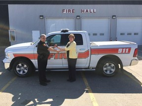 Brian Starkell, Nipawin's fire chief, takes the keys to the new Town of Nipawin fire vehicle from Rennie Harper, Mayor of Nipawin.