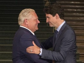 Ontario Premier Doug Ford greets Canadian Prime Minister Justin Trudeau at the Ontario Legislature, in Toronto on Thursday, July 5, 2018.