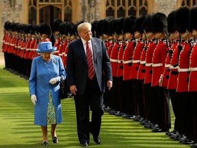 Britain's Queen Elizabeth II (L) and US President Donald Trump (R) inspect the guard of honour formed of the Coldstream Guards during a welcome ceremony at Windsor Castle in Windsor, west of London, on July 13, 2018 on the second day of Trump's UK visit, after a tumultuous first day with Britain's prime minister Theresa May which coincided with the release of Trump's interview with the Sun, in which he blasted May for her handling of Brexit.