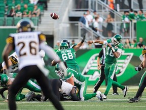 Saskatchewan Roughriders head coach Chris Jones rotated quarterbacks Brandon Bridge, 16, and David Watford against the Hamilton Tiger-Cats on Thursday. The unconventional strategy did not prevent the Roughriders from winning 18-13.