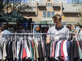 SASKATOON,SK--JULY 05 9999-NEWS-2nd Ave- Ethan Anders looks through racks of T-shirts during the annual Second Avenue Sidewalk sale which runs through Saturday in Saskatoon, SK on Thursday, July 5, 2018.