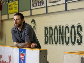 The Humboldt Broncos new head coach, Nathan Oystrick, stands for a photograph on his team's bench on his first official day of work in Humboldt, SK on Wednesday, July 25, 2018.