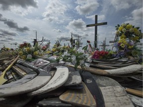 Hockey sticks, messages and other items at a memorial for the Humboldt Broncos bus crash at the intersection of highways 35 and 335 inside the the Rural Municipality of Connaught, SK on Wednesday, August 1, 2018.