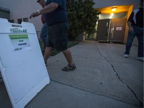 People walk by a sign after leaving the Humboldt Broncos Annual General Meeting at Elgar Petersen Arena in Humboldt, SK on Monday, August 6, 2018.