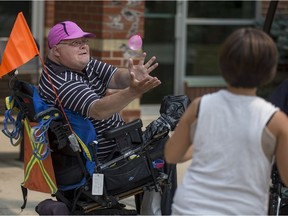 Resident Dave, left, catches a water ballon from employee Carrie Hart during a water balloon fight at Sherbrooke Community Centre in Saskatoon, Sask. on Thursday, August 9, 2018.