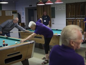 Linda O'Brien plays pool during a sports day located at the Army Navy & Air Force Veterans club for the biannual ANAVETS convention held in Saskatoon, SK on Tuesday, August 14, 2018.