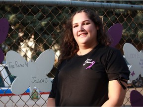 Summer Quewezance stands next to a butterfly in honour of her mother, Tisa Quewezance, who died of HIV/AIDS when Summer was 13, at the 19th Annual Day of Mourning event in Saskatoon, Sask., on Tuesday, August 14, 2018.