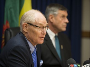 Former Saskatoon police chief Clive Weighill, left, and Justice Minister Don Morgan speak with reporters following Weighill's appointment as chief coroner.