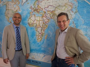 Celso Belo (left) with the Universidade Lurio in Mozambique an Ron Siemens (right) with the University of Saskatchewan stand for a photo in Siemens' home on August 17, 2018.