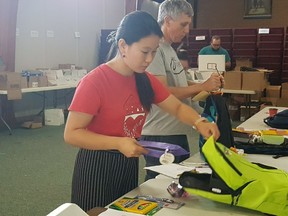 Angela Luo and Randy Robertson fill backpacks for The Salvation Army's back-to-school backpack program on Tuesday, August 21, 2018 in Saskatoon, Sask. This year, the program will provide 1,000 backpacks to children in need.