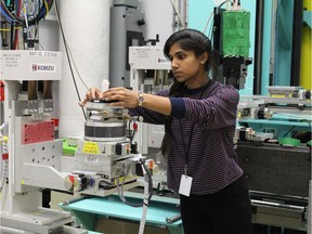 Janani Iyer, a PhD student at Harvard University, places one of 20 specimens on the sample stage of the beamline at Canadian Light Source in Saskatoon, Sask.