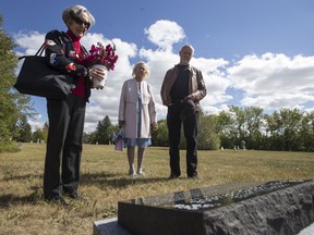 Lynne McLellan, left to right, Geri Street, and Obert Friggstad at the headstone installed on the heretofore unmarked grave of Nevil Pendygrasse at the Nutana cemetery in Saskatoon, SK on Tuesday, August 28, 2018. Obert Friggstad, who lives in the Pendygrasse House on St. Henry, has paid to have a headstone installed. Lynne McLellan and Geri Street are great-nieces of Nevil Pendygrasse.