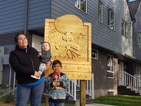 Kehiew Fox and her two children, six-year-old Okimaw, and one and a half-year-old Kingsley, stand outside of Oski Mācipayin, Quint Development's newest affordable housing development. As a single mother, Fox said it was hard to find housing that was appropriate for them, a place where they could have their own space and feel safe — until they moved into Oski Mācipayin.