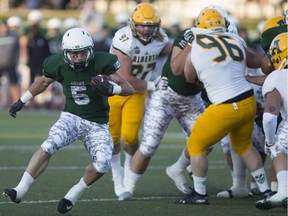 Huskies' running back Tyler Chow totes the ball during Friday's win over Alberta.