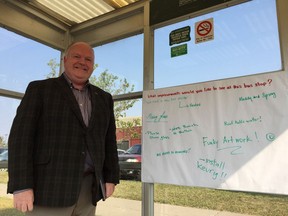 Jim McDonald, director of Saskatoon Transit, stands inside the bus shelter at the corner of 8th Street and McKercher Drive alongside a suggestion sheet put up by the city to ask transit users what changes they would like to see made at city bus stops, in Saskatoon on Thursday Aug. 23, 2018. (Erin Petrow)