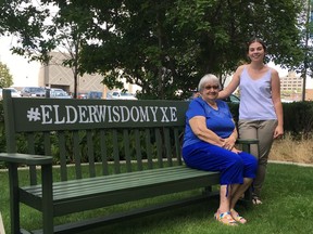 ElderWisdomYXE organizers Janet Olenchuk (left) and Brittany Yaganiski take a seat on the bench that they hope will garner conversations and understanding between seniors and youth in Saskatoon on August 1, 2018. (Erin Petrow/ Saskatoon StarPhoenix)