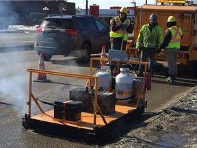 City of Saskatoon workers were testing out new road repair equipment on Thursday on a pothole at the corner of Eighth Street and Arlington Avenue. The new equipment which allows crews to repair potholes in temperatures as low as -10 C and uses infrared technology that generates new hot asphalt using recycled pavement recovered from old road surfaces and a platform which heats the area around the pothole which results in a superior repair.
