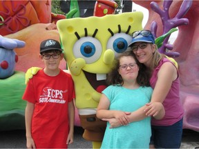 Patti Biwer poses with her daughter Acacia Biwer, 13, and her son Andrew Biwer, 11, at Disney World. Acacia has autism and Down syndrome.