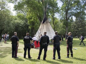 Members of the Regina Police Service attend to Wascana Centre as the Justice For Our Stolen Children camp is dismantled in Regina on June 18.