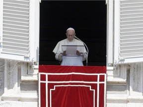 In this Sunday, Aug. 19, 2018 file photo, Pope Francis prays for the victims of the Kerala floods during the Angelus noon prayer in St.Peter's Square, at the Vatican.