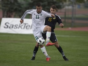 Huskies forward Tyler Redl fights for the ball against Alberta Golden Bears defender Tomasz Chodorski during the Canada West menÕs soccer home-opener at Nutrien Park in Saskatoon, Sk on Saturday, September 1, 2018.