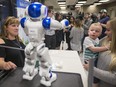 One-year-old Kade Millions and his mother Alyssa Millions, along with Gale Gariepy (left) with a humanoid robot, which is intended to bring young patients comfort and brighten spirits while in hospital. A tribute in the form of the robot from Gariepy to the pediatric unit at Royal University Hospital was made for her son, Mason, a Make-A-Wish recipient, during a media event at RUH in Saskatoon, SK on Wednesday, Sept. 5, 2018.