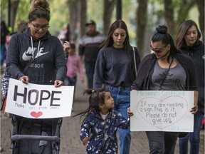 SASKATOON,SK--SEPTEMBER 08 0907-NEWS-Messages of Hope- Organizer Amanda Sanderson (R) of the Messages of Hope campaign walks with a sign during a solidarity walk to raise awareness on suicide in Saskatoon, Sk on Saturday, September 8, 2018.