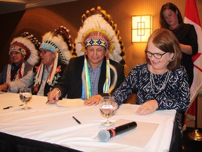 Minister of Indigenous Services Jane Philpott and Saskatoon Tribal Council Chief Mark Arcand sign a letter of understanding on Sept. 11, 2018 at the Radisson Hotel in Saskatoon. The letter of understanding is the start of a partnership between the Federal Government and the STC that will see $56.2 million given to the STC to create programming that will keep families together and children out of care.