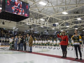Surviving players from the Humboldt Broncos bus crash Brayden Camrud , left to right, Derek Patter, Tyler Smith, Jacob Wasserman, Graysen Cameron, Bryce Fiske, Xavier LaBelle, Nick Shumlanski, Matthieu Gomercic and Kaleb Dahlgren during the national anthem prior to the Broncos home opener game against the Nipawin Hawks in Humboldt, SK on Wednesday, September 12, 2018.