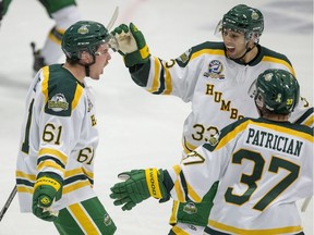 Humboldt Broncos forward Michael Clarke, left to right, forward Luke Spadafora, and defenceman Josh Patrician celebrate a goal against the Nipawin Hawks in the Broncos home opener in Humboldt, SK on Wednesday, September 12, 2018.