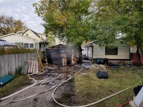 Firefighters respond to a fire at an attached garage at 824 Avenue M South on Wednesday morning. While damage to the structure was extensive, the Saskatoon Fire Department indicated that no one was injured in the blaze.