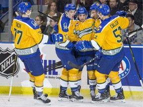 Saskatoon Blades players celebrate a goal against the Swift Current Broncos during Saturday's 8-0 victory at SaskTel Centre.