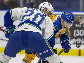 Swift Current Broncos forward Ethan O'Rourke and Saskatoon Blades forward Kirby Dach take a face off during the first period of WHL action at SaskTel Centre in Saskatoon, SK on Saturday, September 22, 2018.