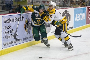 Humboldt Broncos forward Brayden Camrud battles for the puck with Estevan Bruins defenceman Bronson Adams in Warman, SK on Tuesday, September 25, 2018. The Broncos, who are rebuilding their team after 16 people died in an April 6 bus crash beat the Estevan Bruins 6-2 Tuesday at the Legends Centre in Warman. Humboldt is now 3-2, as is Estevan. The SJHL wraps up its four-day series of games in Warman with two contests Wednesday: Nipawin against Notre Dame at 11 a.m., and Humboldt against Melville at 2 p.m.