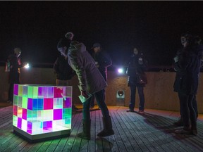 Attendees gather around the art piece 4^3 by Laura Payne during the annual Nuit Blanche art Festival in Saskatoon, Sk on Saturday, September 29, 2018.