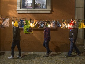 People walk past an art installation by Dee Lowe during the annual Nuit Blanche art festival in Saskatoon, Sk on Saturday, September 29, 2018.