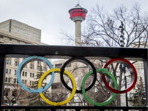 The Calgary Tower is seen with Olympic rings built into railing at Olympic Plaza in downtown Calgary, Alta., on Monday, March 20, 2017. The city is considering another Winter Olympics bid. Lyle Aspinall/Postmedia Network