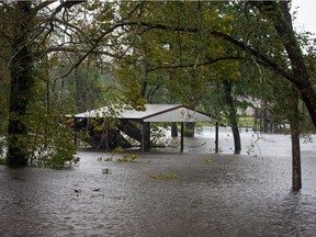 Flood waters from the Trent River inundate a park in Pollocksville, North Carolina on September 14, 2018 during Hurricane Florence. - Florence smashed into the US East Coast Friday with howling winds, torrential rains and life-threatening storm surges as emergency crews scrambled to rescue hundreds of people stranded in their homes by flood waters. Forecasters warned of catastrophic flooding and other mayhem from the monster storm, which is only Category 1 but physically sprawling and dangerous.