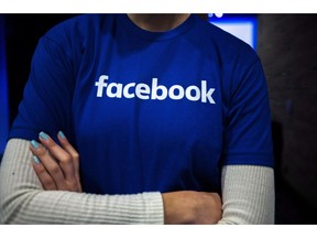 Facebook is launching a new feature in Canada that allows users to get more information on who is behind articles and content on the platform. Guests are welcomed by people in Facebook shirts as they arrive at the Facebook Canadian Summit in Toronto on Wednesday, March 28, 2018.