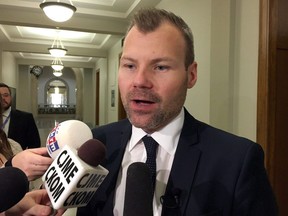 Environment Minister Dustin Duncan scrums with reporters at the provincial legislature, in Regina on Thursday, Nov. 17, 2016.