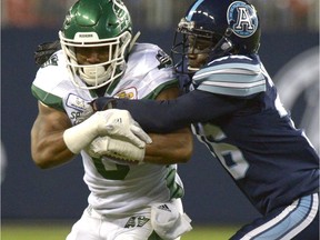 Saskatchewan's Marcus Thigpen, 8, tries to fight off a second-half tackle by Toronto's Trumaine Washington on Saturday at BMO Field.