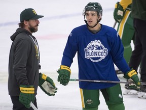 Humboldt Broncos returning player Brayden Camrud speaks with head coach Nathan Oystrick during a team practice Tuesday, Sept. 11, 2018. The Broncos will host the Nipawin Hawks during the season home opener.