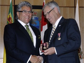 Saskatchewan Senator Bob Peterson presents Leader-Post Publisher Marty Klyne, left, with the Queen Elizabeth II Diamond Jubilee Medal in October 2012.