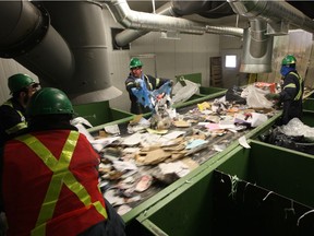 Workers at Loraas Disposal Services Ltd. sort materials collected through the city's recycling program in this 2013 photo. The City of Saskatoon is considering removing glass from the list of acceptable items to be deposited in recycling carts and bins.