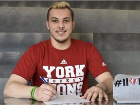 Humboldt Broncos' forward Kaleb Dahlgren signs his letter of intent to play hockey with York University.